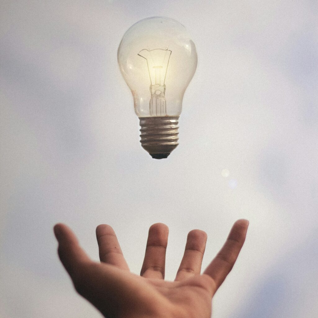 Idea generation. Picture of a hand and a lightbulb